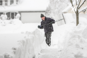 man demonstrating proper technique to prevent snow shoveling back pain